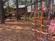 The backyard has a play area surrounded by pine straw at 917 Queensferry Rd, Cary, NC 27511