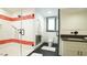 Modern bathroom featuring a glass shower with red and white tile and dual shower heads at 917 Queensferry Rd, Cary, NC 27511