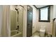 Bright bathroom with a shower, toilet, gray door and trim, and a window at 917 Queensferry Rd, Cary, NC 27511