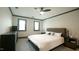 Inviting bedroom with two windows, carpet, ceiling fan, and a large bed at 917 Queensferry Rd, Cary, NC 27511