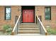 Inviting front entry with bold red doors and meticulously maintained brick steps and landscaping at 917 Queensferry Rd, Cary, NC 27511