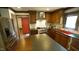 Modern kitchen with custom cabinets, stainless steel appliances, dark counter tops, and a red island at 917 Queensferry Rd, Cary, NC 27511