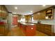 Wide shot of an eat-in kitchen features a center island, stainless steel appliances, and wood cabinets at 917 Queensferry Rd, Cary, NC 27511