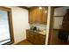 Charming kitchenette with wooden cabinets, granite countertop, and a stylish backsplash at 917 Queensferry Rd, Cary, NC 27511