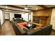 Large living room featuring a brick fireplace, wood floors, and an entertainment center at 917 Queensferry Rd, Cary, NC 27511