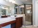 Main bathroom featuring double vanity, stand alone shower, and ample storage space at 921 Marshall Farm St, Wake Forest, NC 27587
