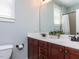 Bathroom features double vanity, granite countertops, and shower with tile surround at 921 Marshall Farm St, Wake Forest, NC 27587