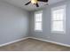 Empty bedroom with a ceiling fan, neutral carpeting, and two large windows for ample natural light at 921 Marshall Farm St, Wake Forest, NC 27587