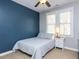 Comfortable bedroom features a blue accent wall, ceiling fan, and neutral carpet at 921 Marshall Farm St, Wake Forest, NC 27587