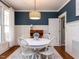 Elegant dining room featuring wainscoting, modern lighting, and a white table setting at 921 Marshall Farm St, Wake Forest, NC 27587
