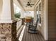 Relaxing front porch with rocking chairs and a ceiling fan for enjoying the outdoors at 921 Marshall Farm St, Wake Forest, NC 27587