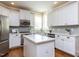 Modern kitchen boasts stainless steel appliances, a center island, and ample cabinet space at 921 Marshall Farm St, Wake Forest, NC 27587