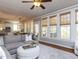 Bright living room features hardwood floors, ceiling fan, and large windows with woven shades at 921 Marshall Farm St, Wake Forest, NC 27587
