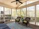 Screened porch with views of the backyard, vaulted ceilings with ceiling fan and comfortable rocking chairs at 921 Marshall Farm St, Wake Forest, NC 27587