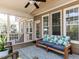 Covered porch with wood decking, stylish seating, and views of the landscaped backyard at 921 Marshall Farm St, Wake Forest, NC 27587