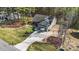 Aerial shot of a well-maintained home with a beautiful yard, landscaping, and a long driveway at 97 Silver Creek Dr, Clayton, NC 27520