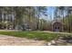 View of the backyard featuring an above ground pool, shed, and wooded scenery at 97 Silver Creek Dr, Clayton, NC 27520