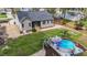 Aerial view of backyard featuring an above ground pool, a landscaped yard, and a screened in back porch at 97 Silver Creek Dr, Clayton, NC 27520