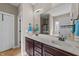 Bathroom features double sinks with granite countertop, wood cabinets, and large mirror at 97 Silver Creek Dr, Clayton, NC 27520