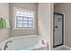 Bathroom features large bathtub with shower, and a window offering lots of natural light at 97 Silver Creek Dr, Clayton, NC 27520