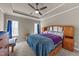 Spacious bedroom features a ceiling fan, tray ceiling, and an abundance of natural light at 97 Silver Creek Dr, Clayton, NC 27520