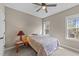 Bedroom with neutral walls and carpet, ceiling fan, and large window with natural light at 97 Silver Creek Dr, Clayton, NC 27520