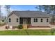 Exterior of the home featuring a screened-in back porch, backyard, and neutral vinyl siding at 97 Silver Creek Dr, Clayton, NC 27520