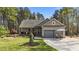 Charming single-story home featuring a cozy front porch, a two-car garage, and beautifully landscaped front yard at 97 Silver Creek Dr, Clayton, NC 27520