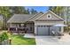 Charming single-story home featuring a cozy front porch, a two-car garage, and beautifully landscaped front yard at 97 Silver Creek Dr, Clayton, NC 27520