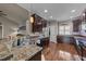 Spacious kitchen with stainless steel sink, dark wood cabinets and a view of the adjoining living room at 97 Silver Creek Dr, Clayton, NC 27520