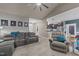 Cozy living room featuring plush seating, a ceiling fan, neutral walls, and an adjoining kitchen at 97 Silver Creek Dr, Clayton, NC 27520