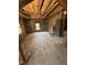 Unfinished living room with wood walls, exposed ceiling beams, and a vintage heater at 1005 Chatham St, Sanford, NC 27330