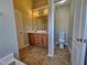 Bathroom with double sink vanity, a commode and a door to an additional commode and shower at 1036 Steelhorse Dr, Fuquay Varina, NC 27526