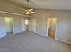 Spacious bedroom featuring carpet, a ceiling fan, and multiple doors leading to other rooms at 1036 Steelhorse Dr, Fuquay Varina, NC 27526