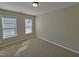 Carpeted bedroom with neutral walls, a window letting in natural light, and base molding at 1036 Steelhorse Dr, Fuquay Varina, NC 27526
