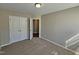 Bedroom featuring neutral paint, carpet and a closet with classic double doors at 1036 Steelhorse Dr, Fuquay Varina, NC 27526