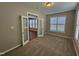 Bedroom featuring carpet flooring and an office area with natural light from multiple windows at 1036 Steelhorse Dr, Fuquay Varina, NC 27526