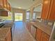 Galley kitchen with stainless appliances, granite countertops, and tile backsplash at 1036 Steelhorse Dr, Fuquay Varina, NC 27526