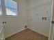 Laundry room with wood floors, a window, laundry hook-ups, and a wire rack for storing at 1036 Steelhorse Dr, Fuquay Varina, NC 27526