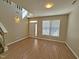 Inviting living room with wood floors, large window, and a welcoming entry at 1036 Steelhorse Dr, Fuquay Varina, NC 27526