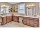 Elegant bathroom with double vanity, granite counters, stylish mirrors, and built-in shelving for decor at 1038 Branwell Dr, Durham, NC 27703