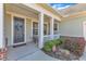 Covered front porch with white columns, seating area, and neatly trimmed landscaping at 1038 Branwell Dr, Durham, NC 27703