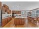 Open kitchen with a large center island, custom cabinets, granite counters, and stainless steel appliances at 1038 Branwell Dr, Durham, NC 27703