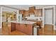 Spacious kitchen with an island, granite countertops, stainless steel appliances, and hardwood flooring at 1038 Branwell Dr, Durham, NC 27703