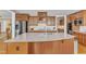 Close up of a kitchen island with granite counters, custom wood cabinets, and stainless appliances in the background at 1038 Branwell Dr, Durham, NC 27703
