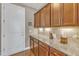 Kitchen features granite counters, wood cabinets, and large counter space along wall at 1038 Branwell Dr, Durham, NC 27703