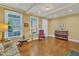 Cozy living room featuring gleaming hardwood floors, sunlit windows, and refined decor at 1038 Branwell Dr, Durham, NC 27703