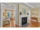 Living room features a fireplace and doorway access to another living area with bright windows at 1038 Branwell Dr, Durham, NC 27703