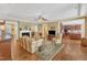 Cozy living room with hardwood floors, fireplace, and access to the kitchen and other living areas at 1038 Branwell Dr, Durham, NC 27703