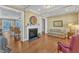 Warm living room with fireplace, hardwood flooring, neutral paint colors, and comfortable furnishings at 1038 Branwell Dr, Durham, NC 27703